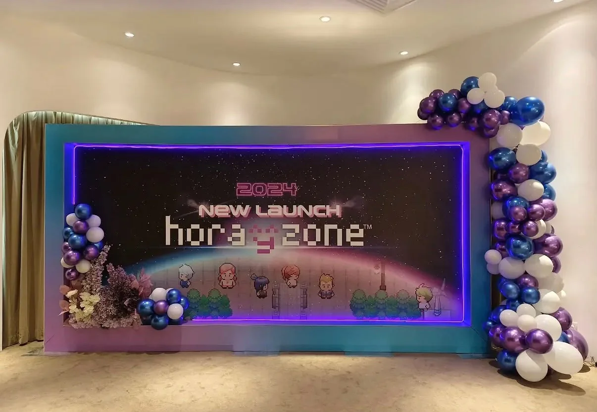 Corporate launch backdrop with violet lighting and balloon styling