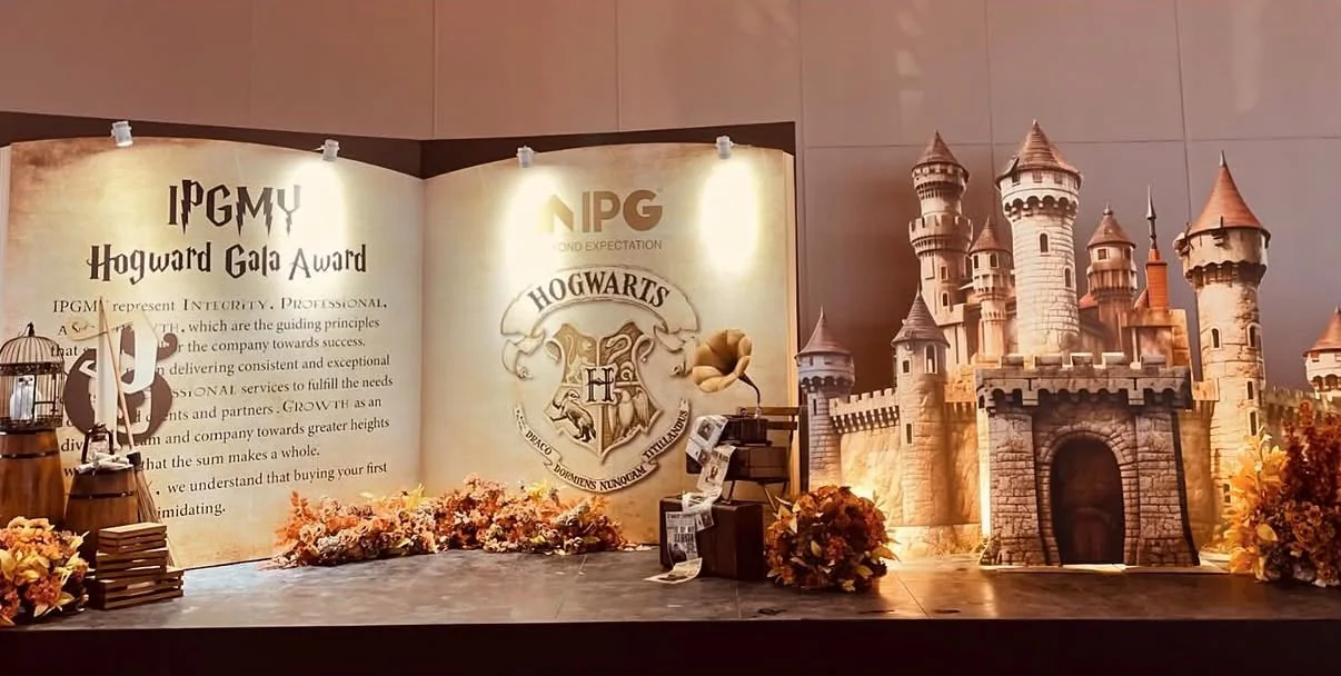 Corporate gala stage with a castle display, flowers and themed backdrop