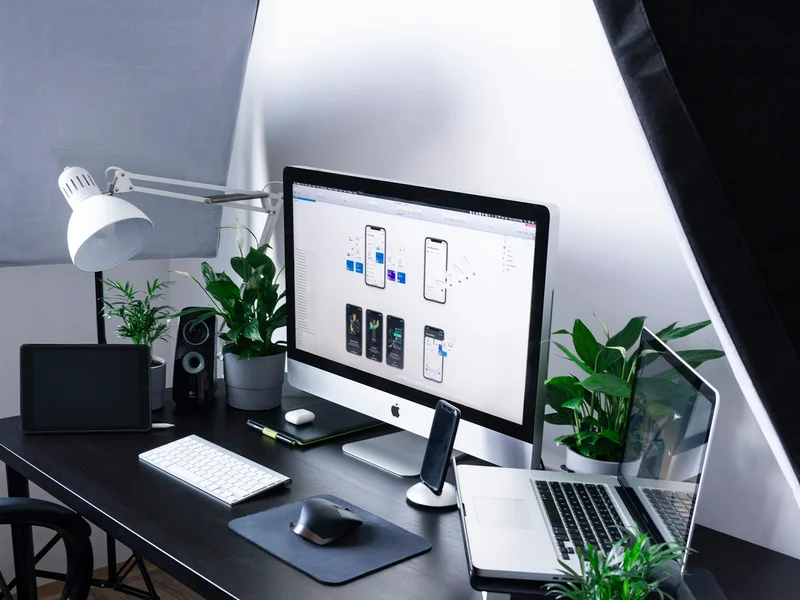 Digital design workspace with desktop and laptop screens